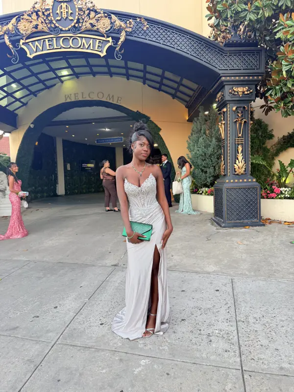 Rose at prom in a sparkling ivory gown with a green clutch